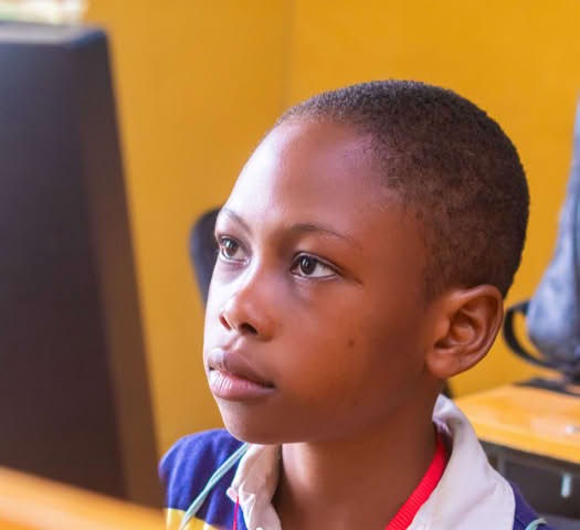 Young person looking at a computer screen