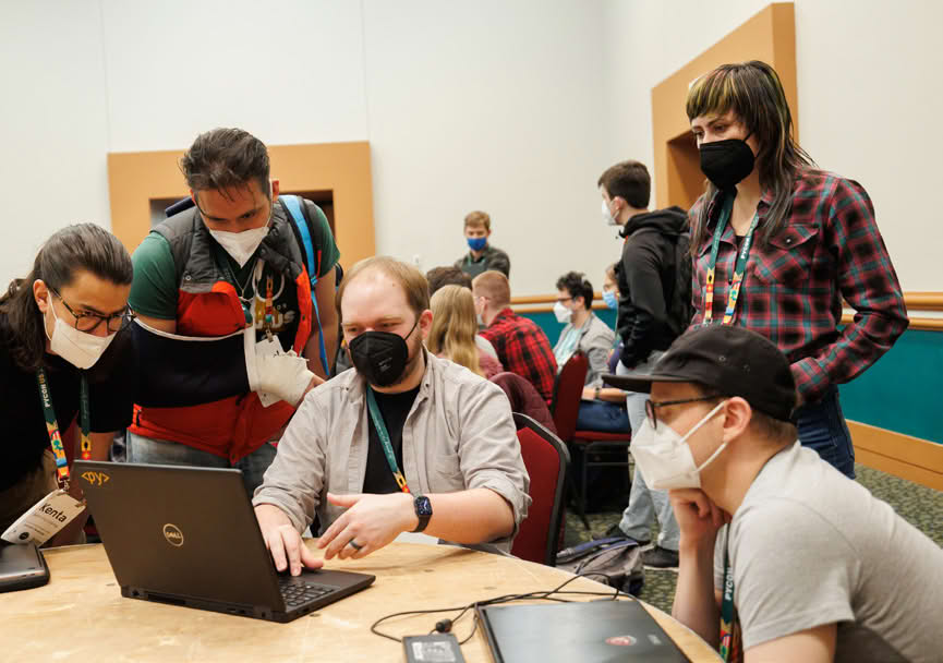 Group of people collaborating on a project with laptops