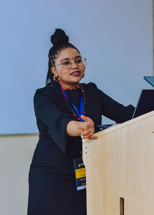 A person standing at a podium, giving a presentation